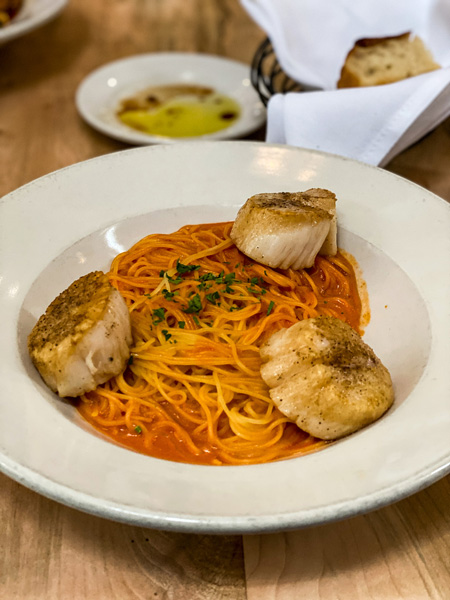 Chiesa Restaurant Asheville Pasta with three scallops and dish of olive oil and bread in background
