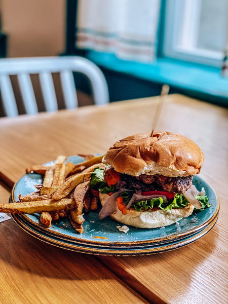 Early Girl Eatery Lunch Downtown Asheville NC with burger on a blue plate with fries