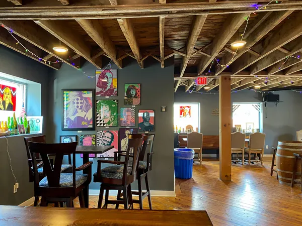 Eurisko Taproom Asheville NC with gray walls, tables, chairs, and artwork on gray walls