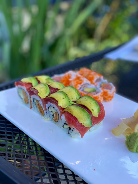 Green Tea Sushi Asheville NC tuna and avocado rolls on white plate with orange roe