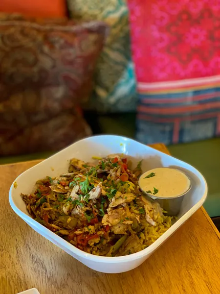 Gypsy Queen Cuisine Asheville NC with bowl of rice with red and green peppers and sauce