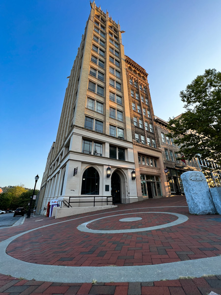 Haunted Pack Square Asheville NC with tall historic building with bullseye in the pavement