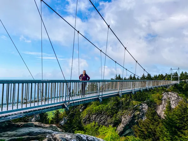 Mile High Swinging Bridge Grandfather Mountain with white brunette woman in middle of a walking bridge