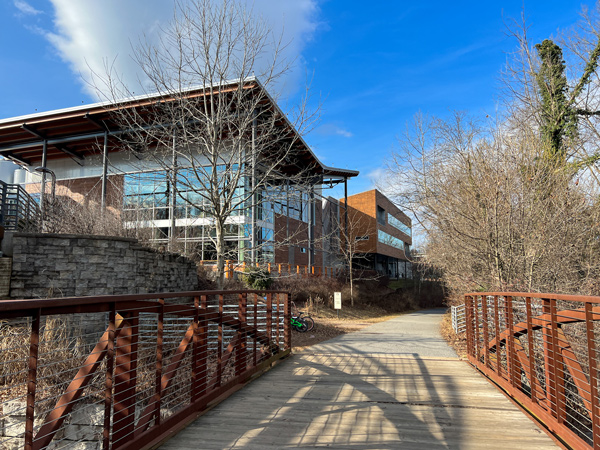 New Belgium Brewing in Asheville NC Facility from wooden bridge trail with large windowed building in background