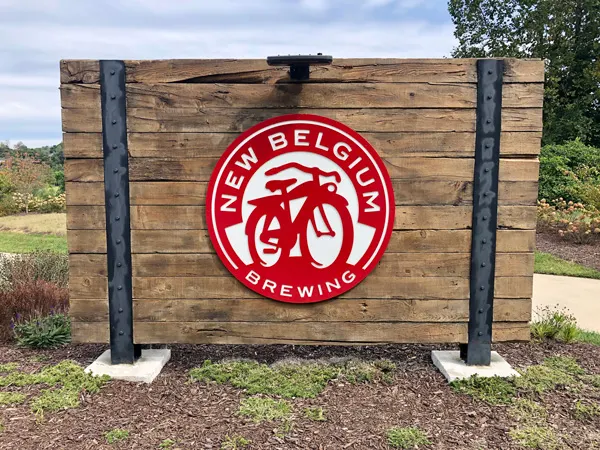 New Belgium Brewing Asheville NC with logo on wooden sign at entrance