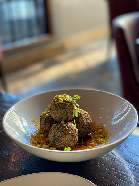 Posana Fine Dine Restaurant Asheville, NC with four gluten-free hush puppies in a white bowl