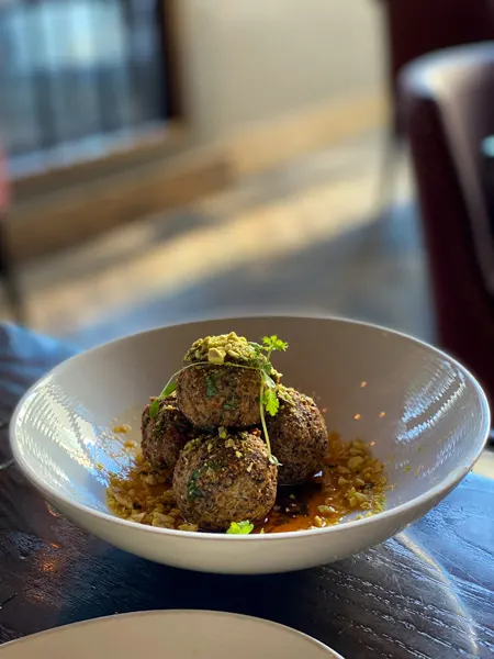 Posana Fine Dine Restaurant Asheville, NC with four gluten-free hush puppies in a white bowl