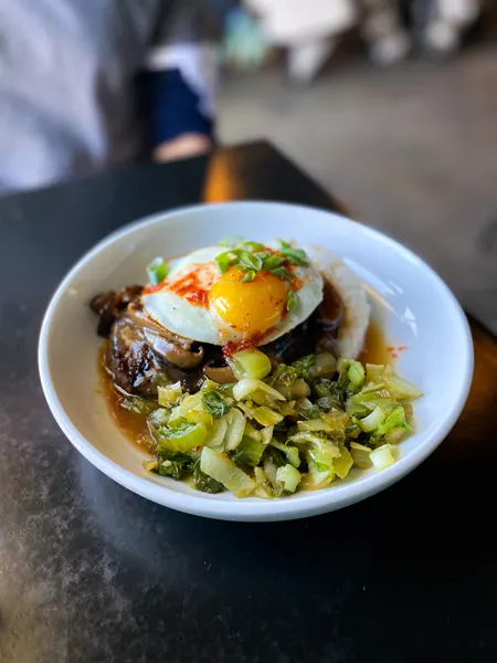 RosaBees Restaurant River Arts District Asheville with bowl filled with sunny side up egg, red sauce, rice and veggies