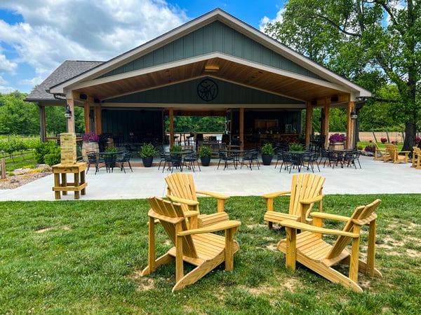 Souther Williams Vineyard Fletcher NC with wooden green tasting room and four wooden chairs in a circle out front