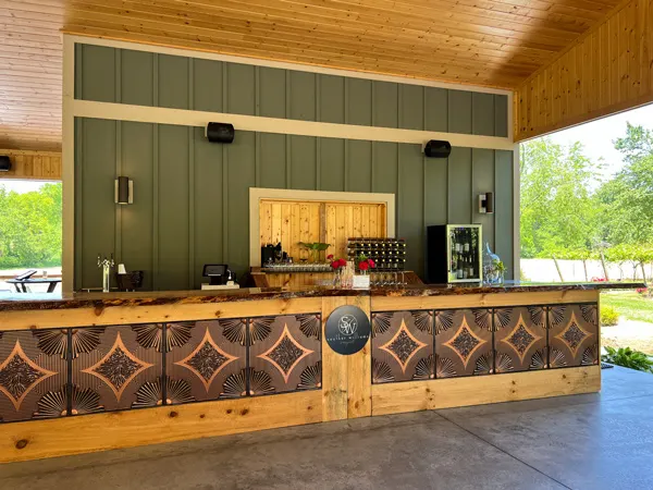 Souther Williams Vineyard Near Asheville NC with tasting bar with green wooden walls and geometric pattern under bar