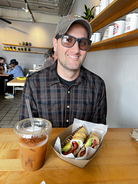 Tom with coffee and lunch at Ultra Coffeebar