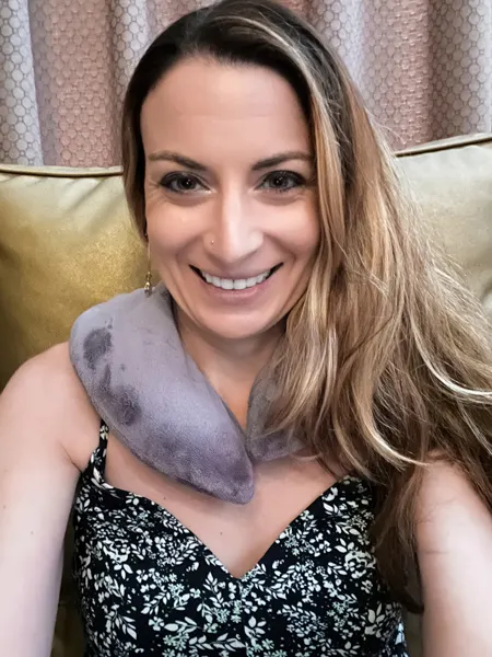 Wake Foot Sanctuary Asheville NC Spa with white brunette woman with blonde highlights taking a selfie wearing a purple gray neck pillow