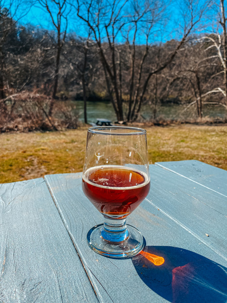 Zillicoah Beer Company Asheville NC with amber beer on picnic table outside