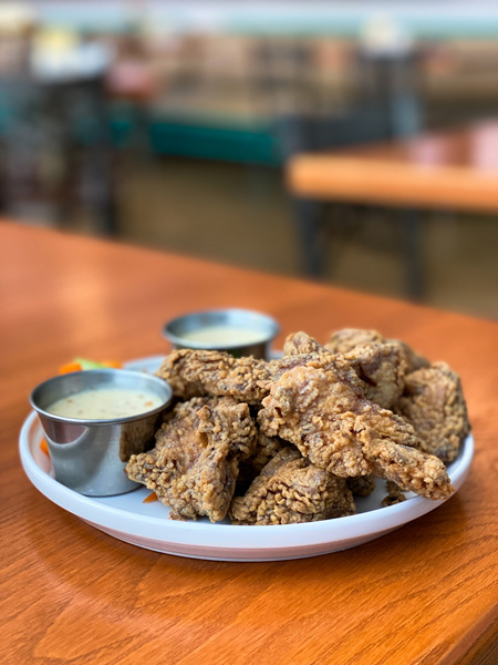 Gluten Free Popcorn Chicken Noble Cider on plate with two honey mustard sauces