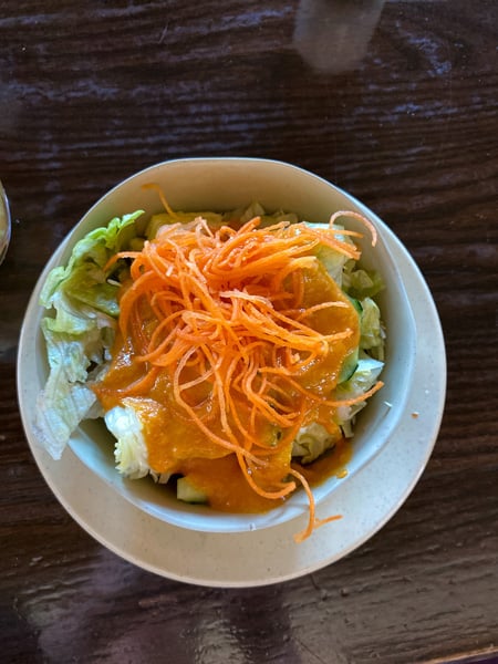 Soba Sushi and Noodles Weaverville NC ginger salad with green lettuce and shredded carrots in white bowl
