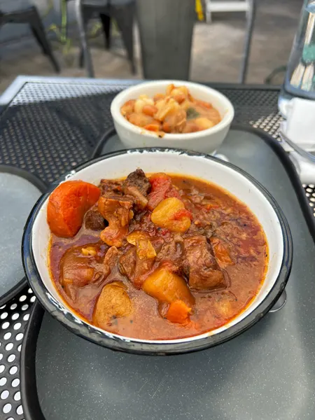 The Bush Farmhouse Restaurant in Black Mountain, North Carolina with oxtail soup with carrots, potatoes, and meat on table