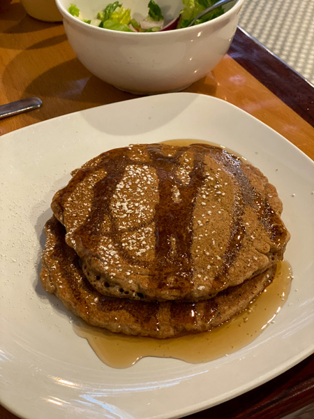 Arabella Hendersonville NC vegan pancakes with syrup on white plate with coffee