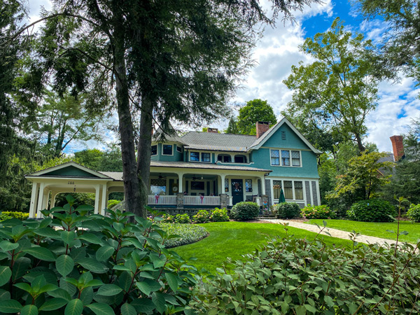 Black Walnut B&B Inn Historic Montford in Asheville NC greenish colored bed and breakfast with front porch and tree