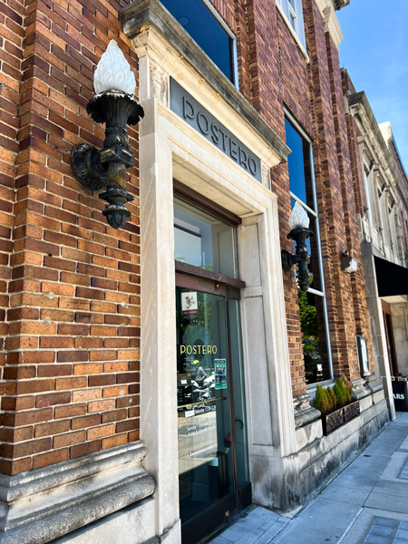 Postero Restaurant Hendersonville with brick facada of building with candles on either side of door