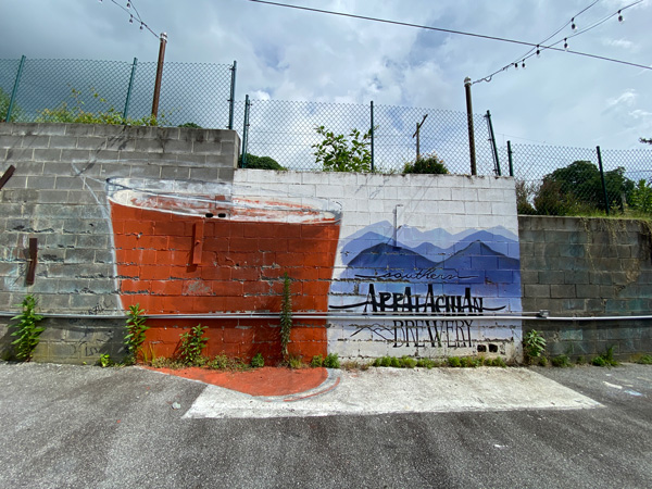 Southern Appalachian Brewery Hendersonville NC mural with Blue Ridge Mountains and amber colored craft beer mural