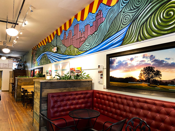 Asheville Chocolate Downtown Asheville NC dessert bar with red cushioned seating and colorfully painted walls