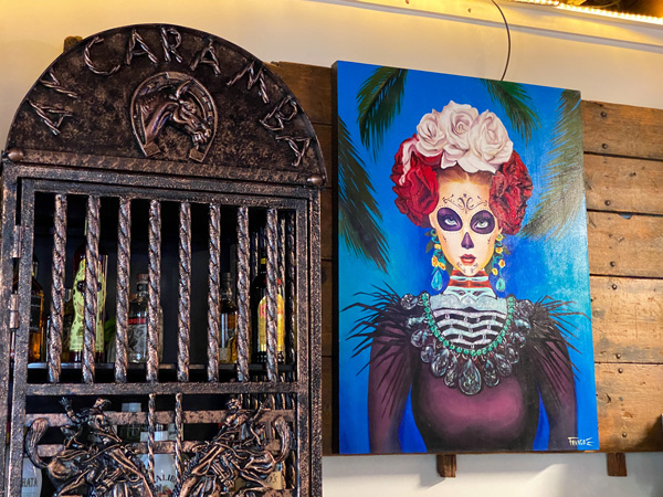 Ay Caramba Mexican Grill with picture of liquor cabinet and Day of Dead painting on wall