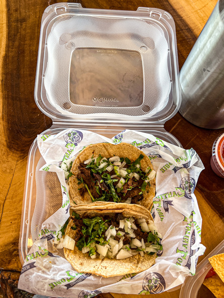 Cantina Louie Tacos Asheville NC with two soft-shell corn tortillas filled with chicken, onion, and cilantro