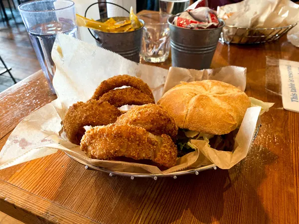 Farm Burger Downtown Asheville NC with vegan burger patty in bun in basket with giant onion rings