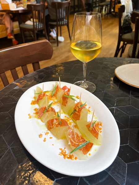 Tapas with white wine at La Bodega by Curate