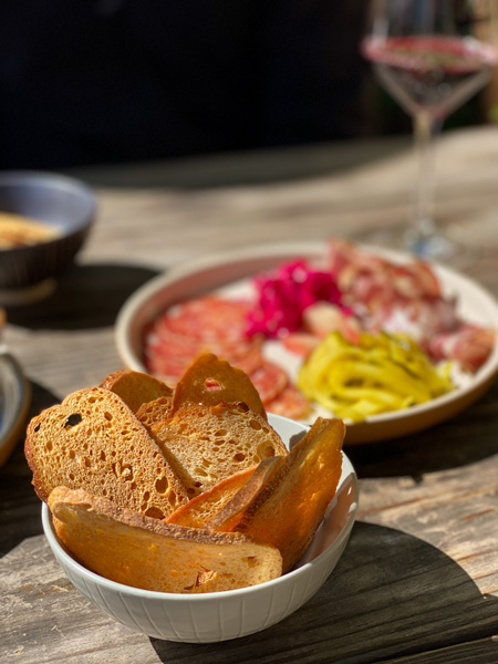 Leos House Of Thirst Asheville with toasted bread, charcuterie and red wine