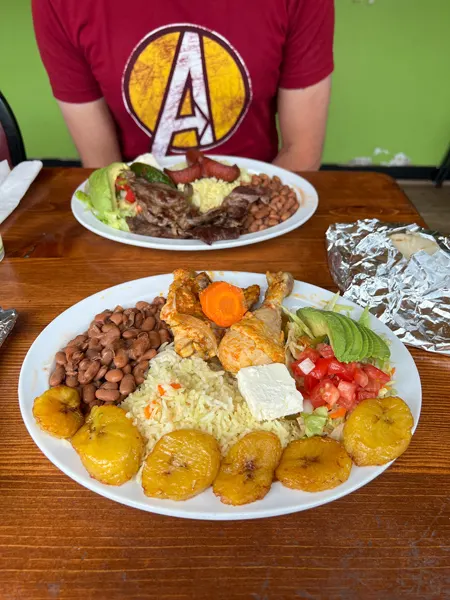 Pupuseria Patty Restaurant Asheville North Carolina with plate of fried plantains, rice and beans, and salad