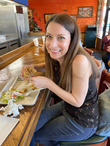 Christine eating Taqueria Munoz Burrito