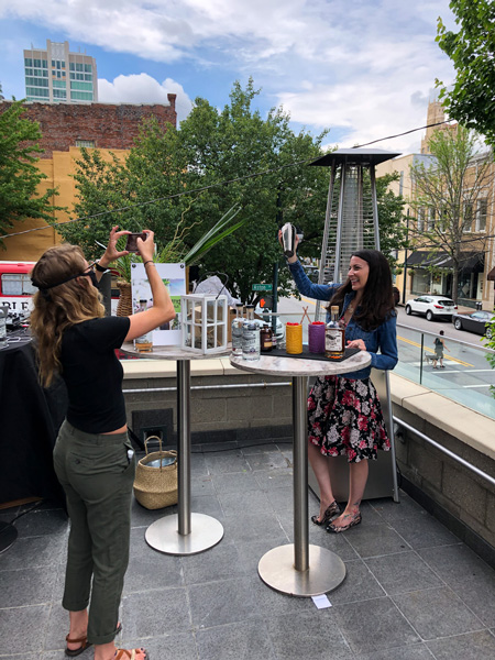 The Ledge Aloft Downtown Rooftop Bar Asheville with two white women making cocktails on a table