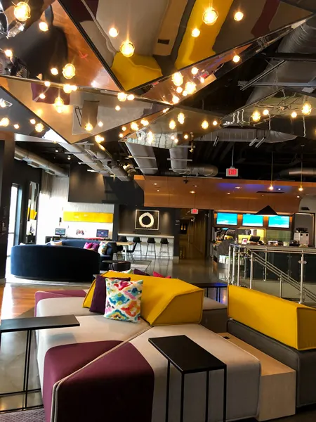 W XYZ Bar in Aloft Downtown Asheville with yellow and purple colorful couches and selfie mirrors