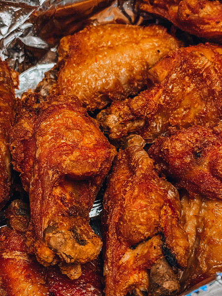 Asheville Brewing Kong Wings with red orange sauce over chicken wings