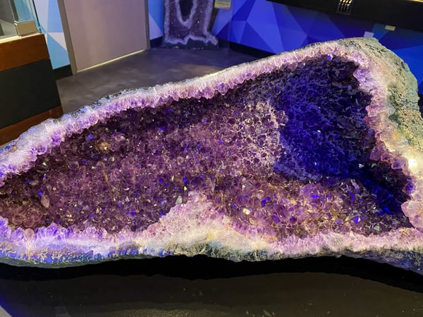Asheville Museum of Science Exhibits with rock cut open to show purple gemstones