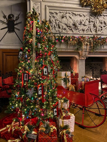 Biltmore Christmas Tree with red sleigh in Banquet room in front of fireplace