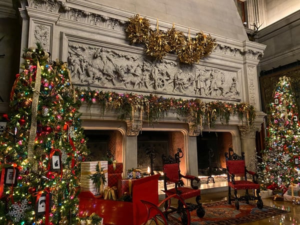 Biltmore Estate Candlelight Christmas Evenings with three-hole fireplace surrounded by two Christmas trees 