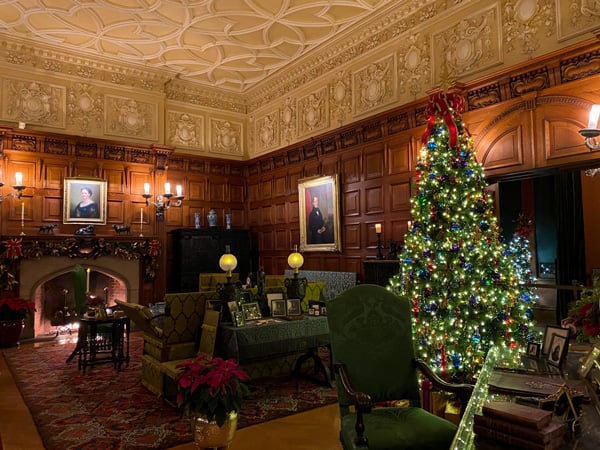 Biltmore House At Christmas with Christmas tree, fireplace, and couches in sitting room