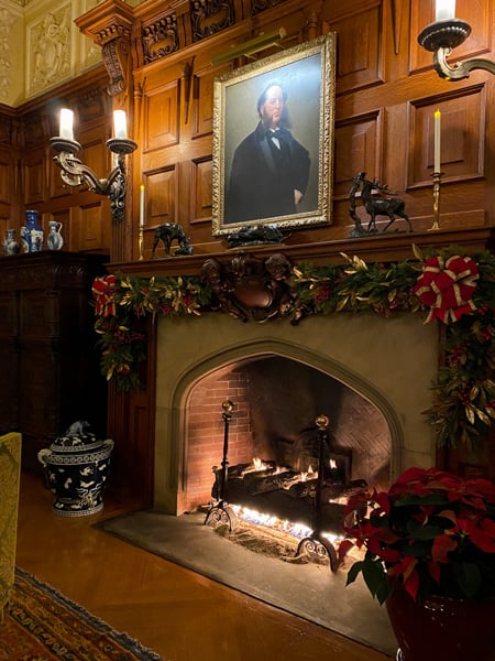 Biltmore House Candlelight Christmas Evenings with lit fireplace and portrait above it