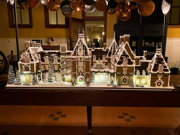 Biltmore House Christmas gingerbread house that is a small replica of Biltmore Home on kitchen table