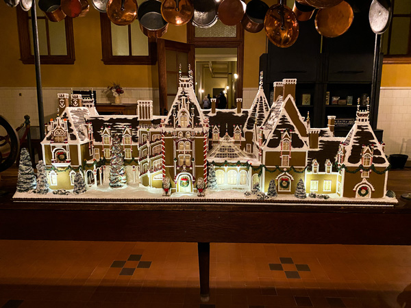 Christmas gingerbread house that is a small replica of Biltmore House on their kitchen table for the holdays