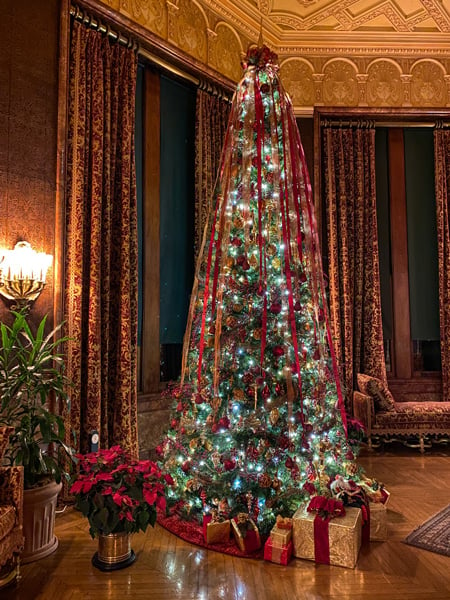 Biltmore House Christmas Tree with red ribbons and presents