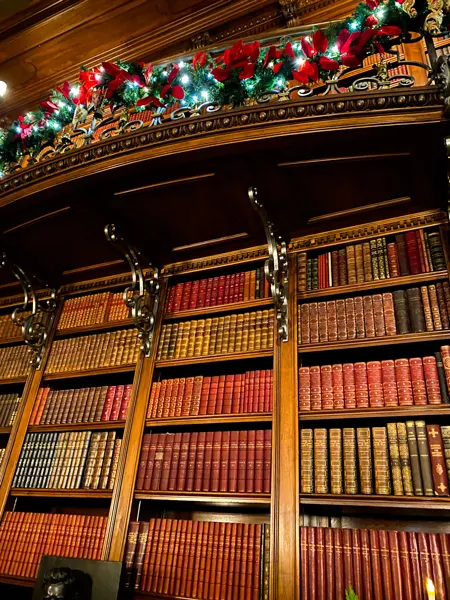 Biltmore library at Christmas with books on bookshelves and garland
