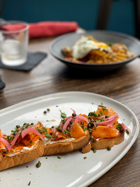 Brunch Downtown Asheville Social Lounge Vegan Lox on toast with egg dish in background