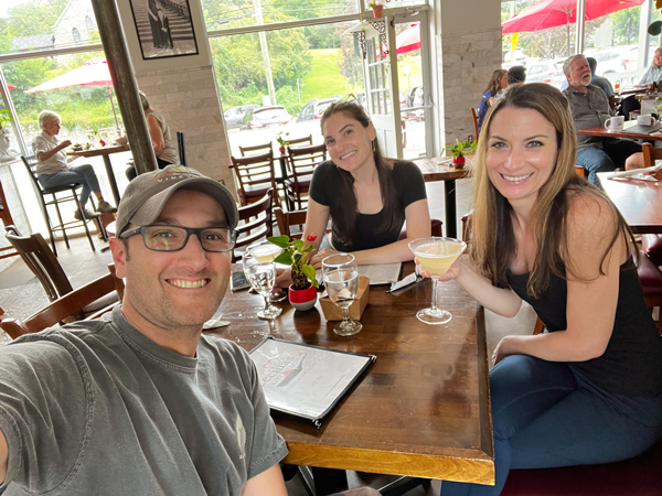 Cecilias' Kitchen Restaurant in Asheville NC with two brunette white women and one brunette white male sitting at a table with drinks