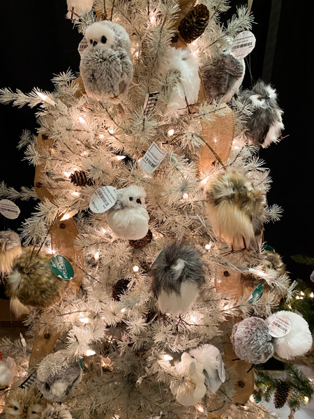 Christmas Shop Winter Lights Festival Asheville with white Christmas tree filled with different shape and color owl ornaments