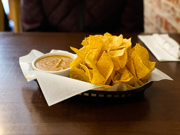 Rosettas Kitchen Vegan and vegetarian Asheville NC with basket of salsa chips and vegan queso for dipping