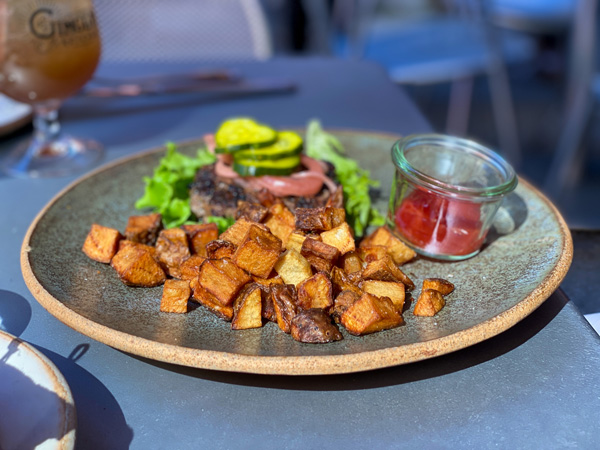 The Market Place Brunch Asheville NC with plate of fried potatoes, burger no bun, and lettuce with pickles