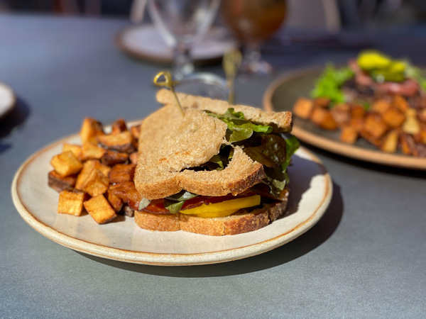 The Market Place Brunch Downtown Asheville NC with tomato sandwich and fried potatoes